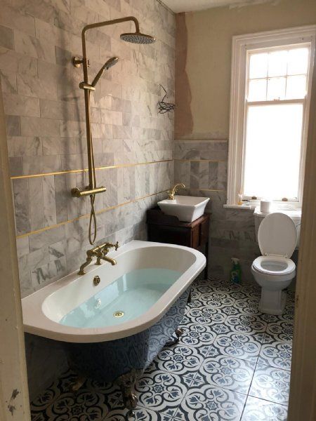 Clawfoot tub bathroom by JC Plumbing